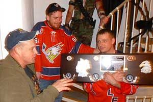 Todd and Paulette Poynter receiving the plaque for retired number 68 in 2012